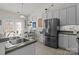 Well lit kitchen with stainless steel refrigerator and a dining area at 2943 Village Center Dr, Dallas, NC 28034