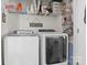 Functional laundry room with modern washer and dryer, shelving, and storage baskets at 2943 Village Center Dr, Dallas, NC 28034