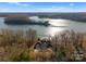 Aerial view of luxury home on waterfront property surrounded by trees and shimmering lake at 296 Windemere Isle Rd, Statesville, NC 28677