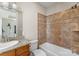 A modern bathroom with granite counters, a large mirror, and a tiled bath at 296 Windemere Isle Rd, Statesville, NC 28677