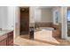 Luxurious bathroom featuring a tiled shower, soaking tub, and elegant finishes at 296 Windemere Isle Rd, Statesville, NC 28677