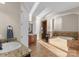 A well-designed bathroom featuring dual sinks, a soaking tub, a tiled shower, and elegant fixtures for a modern appeal at 296 Windemere Isle Rd, Statesville, NC 28677