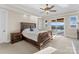 A sunlit primary bedroom with a dark wood sleigh bed and balcony overlooking a scenic view at 296 Windemere Isle Rd, Statesville, NC 28677