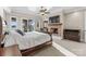 Sunlit bedroom with a fireplace, mounted TV, and access to the outdoor patio at 296 Windemere Isle Rd, Statesville, NC 28677