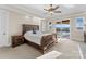 Bright bedroom with a ceiling fan, view to the outdoor patio, and ensuite bathroom at 296 Windemere Isle Rd, Statesville, NC 28677