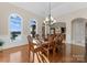 Formal dining room with lake views, hardwood floors, and elegant chandelier at 296 Windemere Isle Rd, Statesville, NC 28677