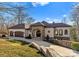 Gorgeous home featuring a stone entrance, arched doorway, and well-manicured lawn at 296 Windemere Isle Rd, Statesville, NC 28677