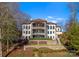 Back elevation view of an elegant home with multiple balconies and beautiful landscaping at 296 Windemere Isle Rd, Statesville, NC 28677