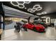 Modern garage with sports car, motorcycles, overhead lighting, and a view to the outdoor landscape at 296 Windemere Isle Rd, Statesville, NC 28677