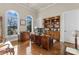 Spacious home office featuring custom wood desk, built-in bookcase and stunning lake views from large arched windows at 296 Windemere Isle Rd, Statesville, NC 28677