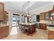 Bright, spacious kitchen with a central island, stainless steel appliances, and a view to the lake at 296 Windemere Isle Rd, Statesville, NC 28677