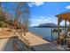 Sandy beach beside a lake leading to a boat dock and lift at 296 Windemere Isle Rd, Statesville, NC 28677