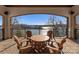 Covered patio features wood table and chairs with gorgeous lake views, perfect for outdoor dining at 296 Windemere Isle Rd, Statesville, NC 28677