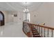 Grand foyer with a curved staircase and elegant chandelier, showcasing luxurious design and craftsmanship at 296 Windemere Isle Rd, Statesville, NC 28677