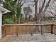 View of the expansive backyard and mature trees from the wooden deck at 3138 Morson St, Charlotte, NC 28208