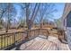 Backyard view from a wooden deck with railing and stairs overlooking the spacious, tree-filled yard at 3138 Morson St, Charlotte, NC 28208