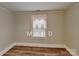 Simple bedroom with hardwood floors and a window at 3138 Morson St, Charlotte, NC 28208