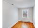 Cozy bedroom with hardwood floors, white trim, and a window for natural light at 3138 Morson St, Charlotte, NC 28208