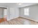 Bright bedroom with light gray walls, laminated floors, and a window offering ample natural light at 3138 Morson St, Charlotte, NC 28208