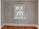 Bedroom featuring hardwood floors, neutral paint and a window bringing in natural light at 3138 Morson St, Charlotte, NC 28208