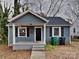 Charming one-story home featuring a welcoming front porch and neat landscaping at 3138 Morson St, Charlotte, NC 28208