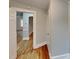 Inviting hallway featuring hardwood flooring and opening to additional rooms at 3138 Morson St, Charlotte, NC 28208