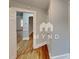 Hallway featuring hardwood floors with white trim and walls painted in a neutral tone at 3138 Morson St, Charlotte, NC 28208