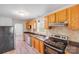 Functional kitchen features oak cabinets, modern appliances, and laminated countertops at 3138 Morson St, Charlotte, NC 28208