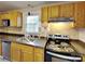 Well-equipped kitchen featuring wooden cabinets, and modern appliances at 3138 Morson St, Charlotte, NC 28208