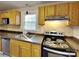 Updated kitchen featuring granite countertops, tiled backsplash and wooden cabinetry at 3138 Morson St, Charlotte, NC 28208