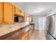 Functional kitchen featuring laminated counters, wooden cabinets, and modern appliances at 3138 Morson St, Charlotte, NC 28208