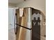 Stainless steel refrigerator in an efficient kitchen with tile flooring at 3138 Morson St, Charlotte, NC 28208