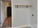 Laundry room with access to another room and a single wooden shelf for storage at 3138 Morson St, Charlotte, NC 28208