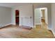 Open-concept living room with hardwood floors, a decorative fireplace and views into the kitchen at 3138 Morson St, Charlotte, NC 28208