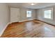 Bright living room with hardwood floors and two windows offering natural light at 3138 Morson St, Charlotte, NC 28208