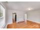 Bright living room featuring hardwood floors, a fireplace, and open layout to the kitchen at 3138 Morson St, Charlotte, NC 28208