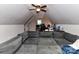 Finished attic space featuring a comfortable sofa and desk area, illuminated by natural light from a window at 3300 Chancellor Ln, Monroe, NC 28110