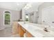 Bright bathroom features a double sink vanity, large mirror, garden tub, and arched window overlooking the green landscape at 3300 Chancellor Ln, Monroe, NC 28110