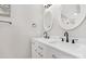 Bathroom with gray walls, double sink vanity with black faucets and patterned white framed mirrors at 3300 Chancellor Ln, Monroe, NC 28110