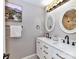 Bathroom featuring double vanity with modern fixtures, lighting, and decorative mirrors at 3300 Chancellor Ln, Monroe, NC 28110