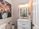 Charming bathroom featuring a white vanity with a marble countertop and a decorative floral painting at 3300 Chancellor Ln, Monroe, NC 28110