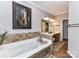 Bathroom featuring a tub, dual vanity, and a decorative painting at 3300 Chancellor Ln, Monroe, NC 28110