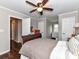 Cozy bedroom featuring hardwood floors and ceiling fan with light fixture at 3300 Chancellor Ln, Monroe, NC 28110