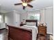 Bedroom featuring hardwood floors, neutral paint, a ceiling fan, and an exterior door at 3300 Chancellor Ln, Monroe, NC 28110