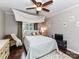 Bedroom featuring a large window with curtains, hardwood floors, and ceiling fan at 3300 Chancellor Ln, Monroe, NC 28110