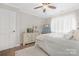 Bedroom features hardwood floors, ceiling fan, and large window at 3300 Chancellor Ln, Monroe, NC 28110