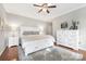 Spacious bedroom with hardwood floors, ceiling fan, and modern furniture at 3300 Chancellor Ln, Monroe, NC 28110