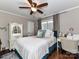 Bedroom with hardwood floors, ceiling fan, a window with curtains, and a vanity at 3300 Chancellor Ln, Monroe, NC 28110