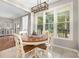 Bright dining area featuring a round table, wood floors, and natural light from the windows at 3300 Chancellor Ln, Monroe, NC 28110