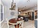 Open concept kitchen and dining area with abundant natural light and warm color palette at 3300 Chancellor Ln, Monroe, NC 28110